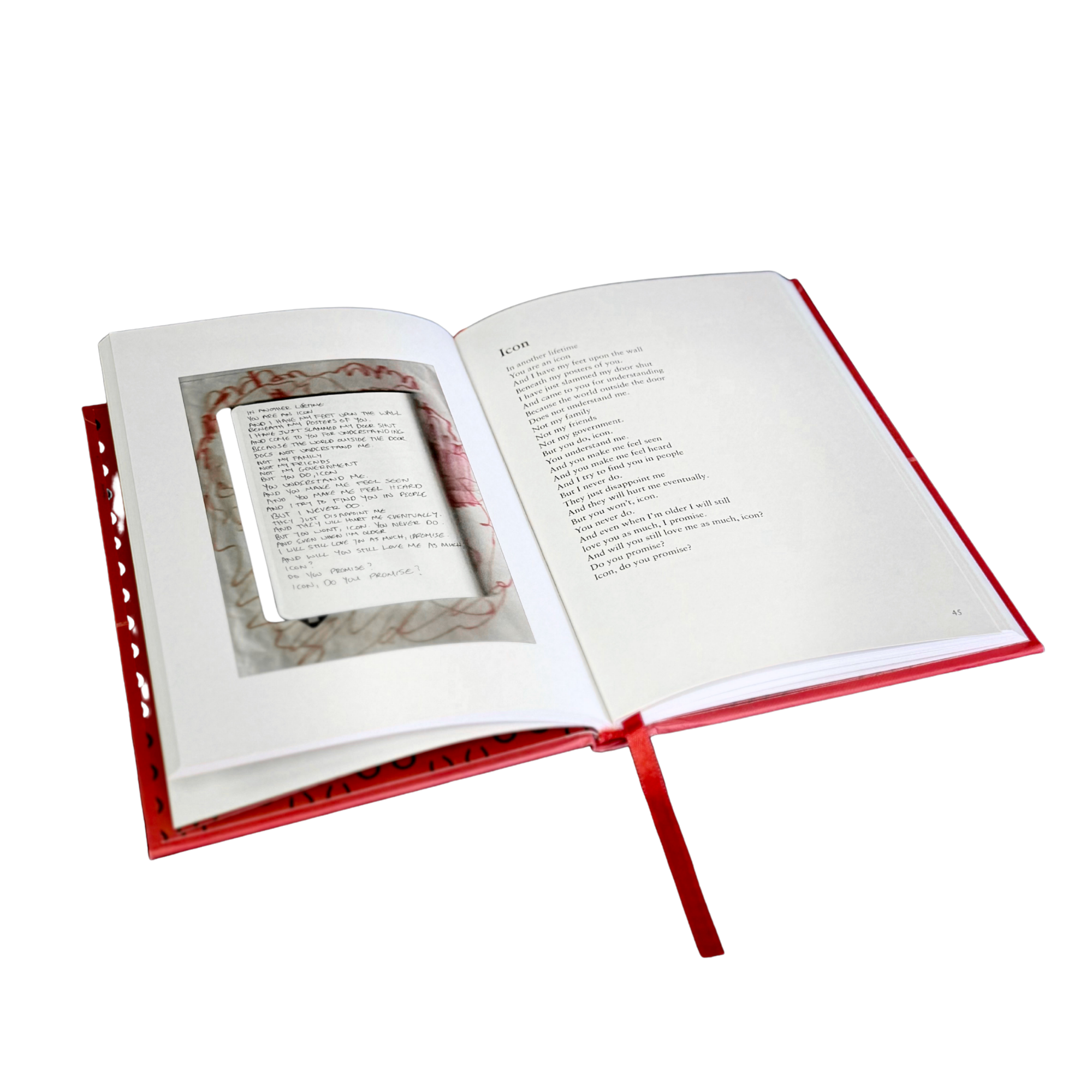 An open hardcover book with a red cover and ribbon bookmark, showing printed text pages and a small inset page or card inside the spread, isolated on a white background.