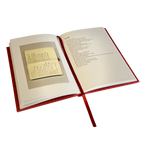 An open hardcover book with a red ribbon bookmark, showing printed text on the right page and a small inset photograph or page on the left page, isolated on a white background.