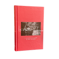 A hardcover book titled 'In Another Lifetime: A collection of poems' by Ryan Hennessy, featuring a textured coral-red cover with a central square black-and-white photograph and white script text.