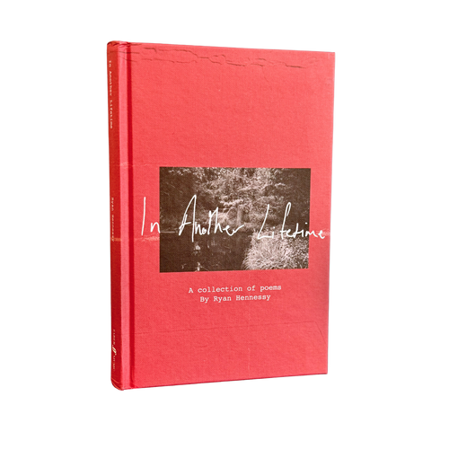 A hardcover book titled 'In Another Lifetime: A collection of poems' by Ryan Hennessy, featuring a textured coral-red cover with a central square black-and-white photograph and white script text.